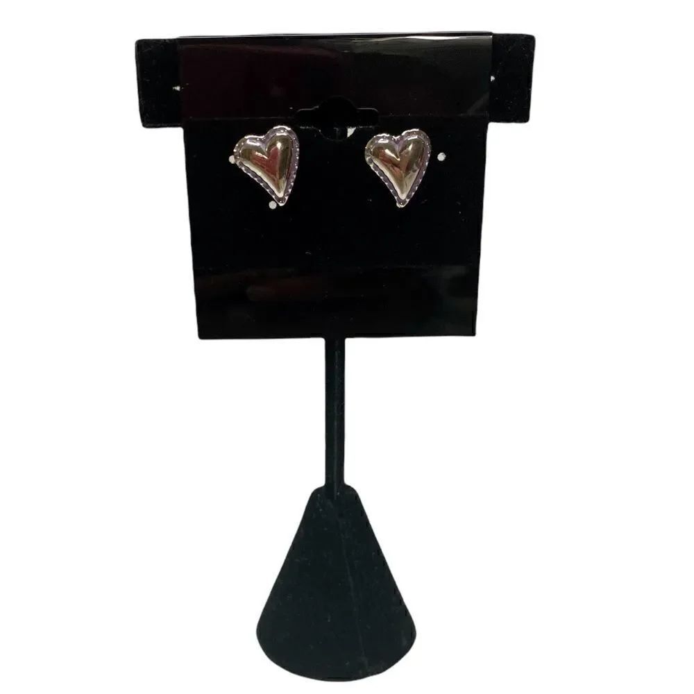 Silver toned small heart studs with black etching.